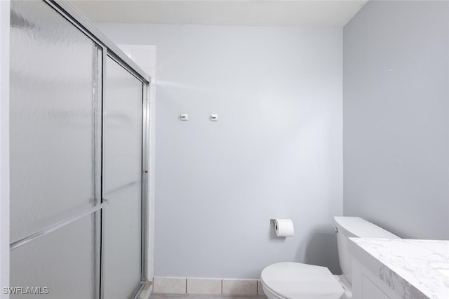 374 Dover Pl Unit 803, Naples, FL 34104 - bathroom with a stall shower, baseboards, toilet, and vanity