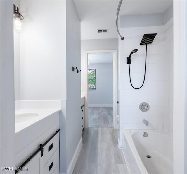 374 Dover Pl Unit 803, Naples, FL 34104 - bathroom with vanity, toilet, visible vents,  shower combination, and wood finished floors