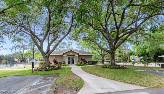 374 Dover Pl Unit 803, Naples, FL 34104 - view of front of property with french doors, playground community, stucco siding, and fence