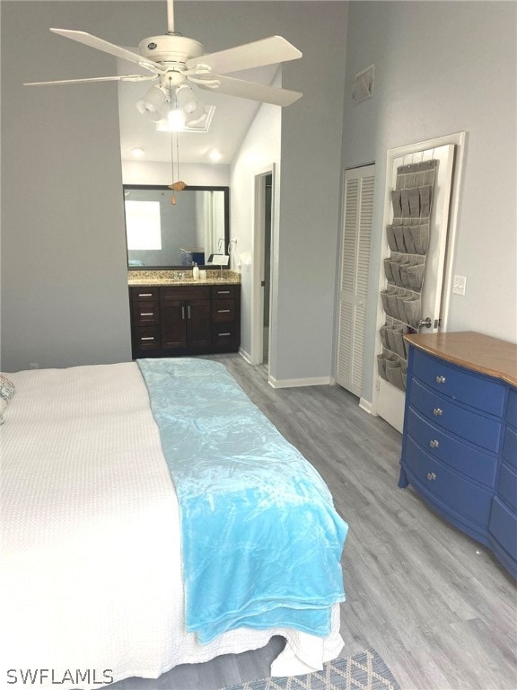 bedroom featuring light hardwood / wood-style floors, ceiling fan, and lofted ceiling