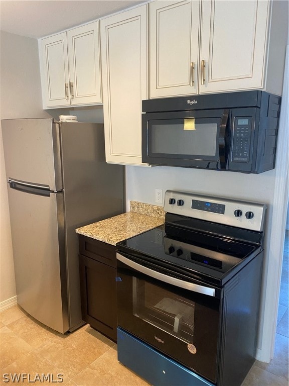 kitchen featuring white cabinets, light tile floors, and appliances with stainless steel finishes