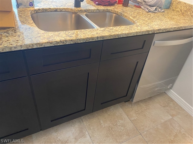 details with light tile flooring, stainless steel dishwasher, and vanity