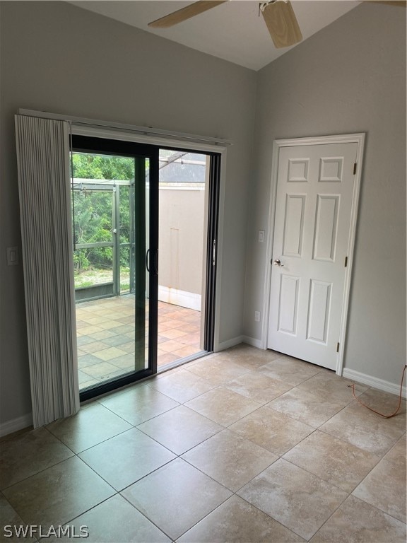 tiled empty room with lofted ceiling and ceiling fan