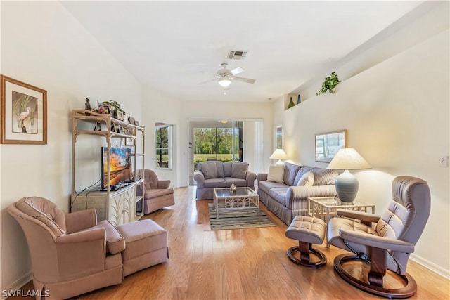 living room featuring ceiling fan and light hardwood / wood-style flooring