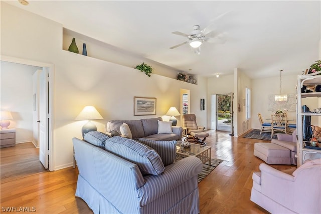 living room featuring hardwood / wood-style floors and ceiling fan