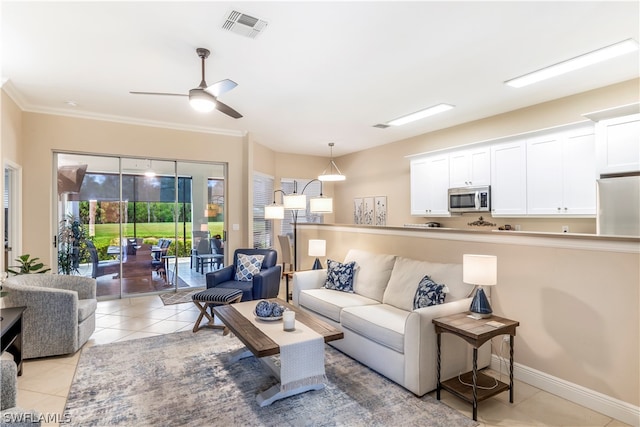 tiled living room featuring a wealth of natural light, ceiling fan, and ornamental molding