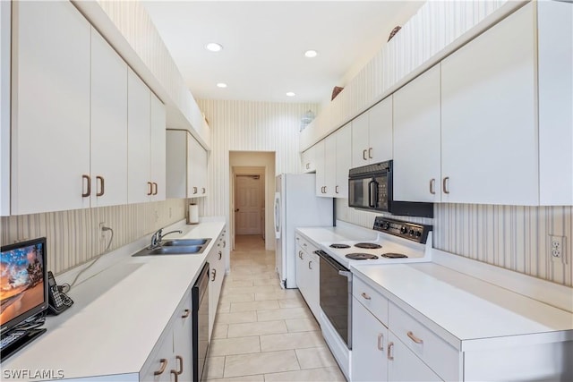 kitchen featuring white cabinetry, white appliances, sink, and light tile patterned floors