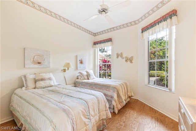 bedroom with ceiling fan and light hardwood / wood-style floors