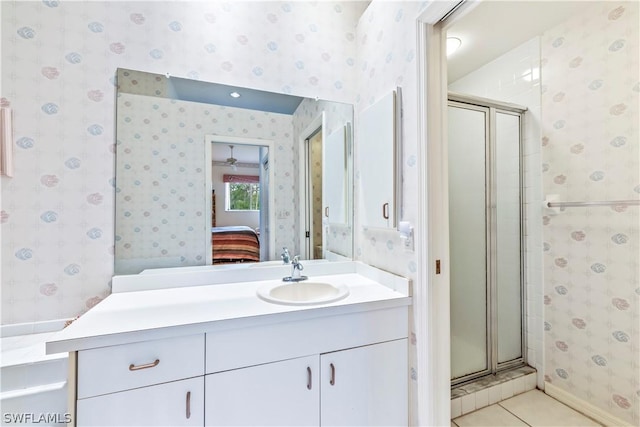 bathroom featuring tile patterned flooring, vanity, and an enclosed shower