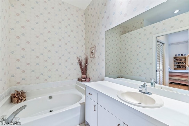 bathroom with a tub to relax in and vanity