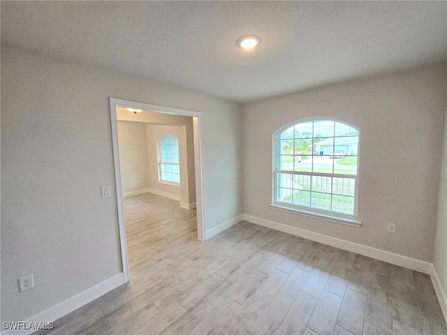 empty room with light hardwood / wood-style floors