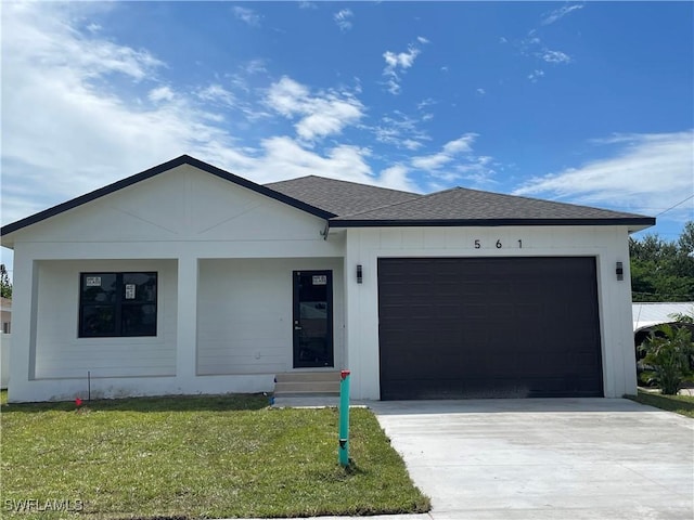 view of front of home with a front yard and a garage