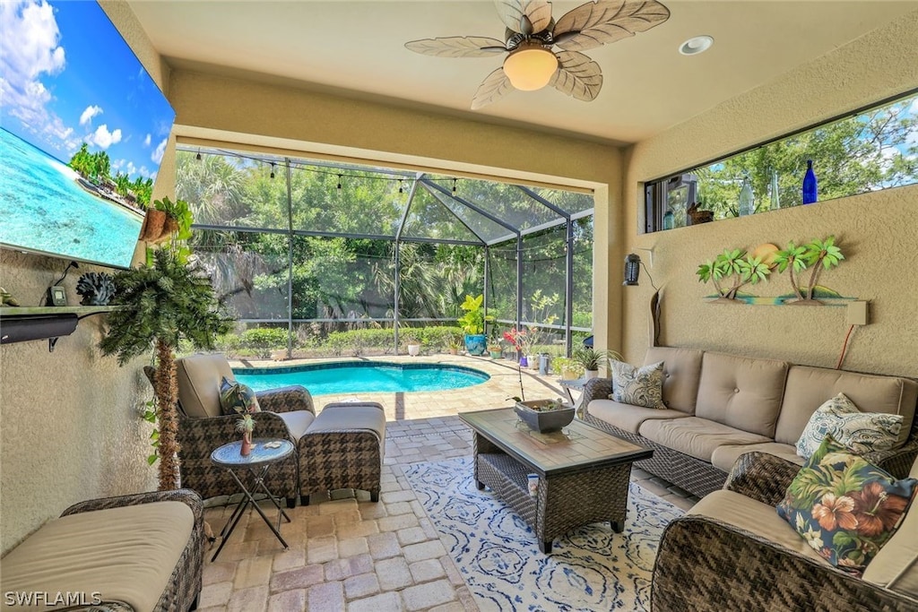 sunroom / solarium featuring ceiling fan