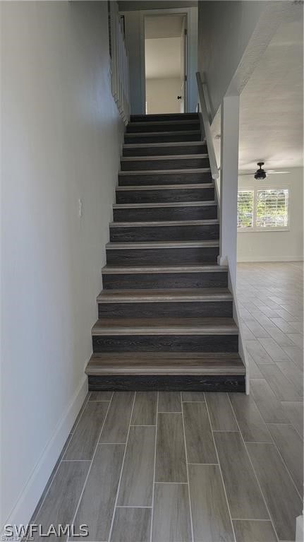 stairs with ceiling fan