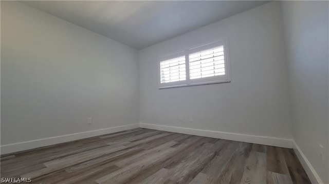 spare room featuring dark wood-type flooring