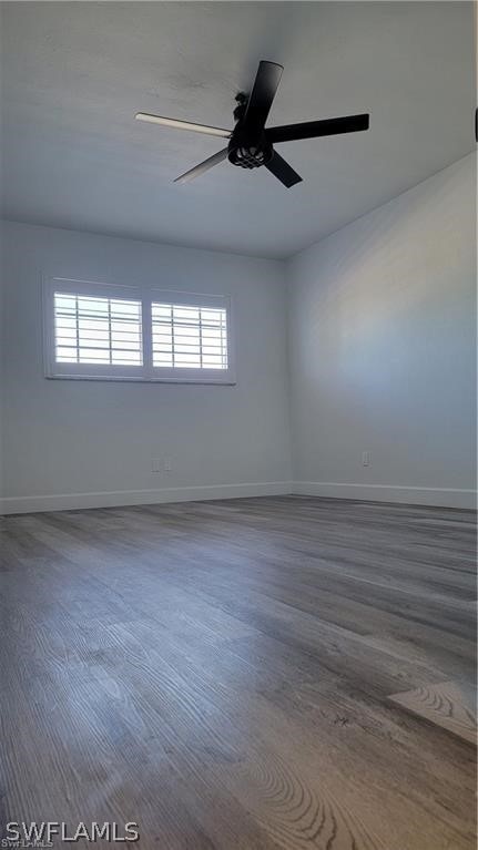 empty room featuring dark hardwood / wood-style flooring and a healthy amount of sunlight