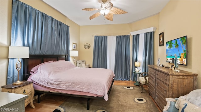 bedroom with hardwood / wood-style flooring and ceiling fan