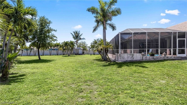 view of yard with glass enclosure