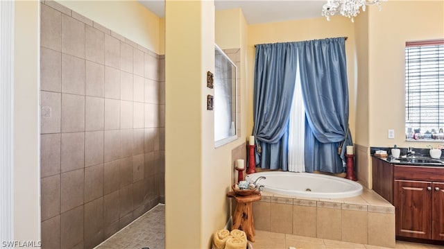 bathroom featuring tile patterned flooring, vanity, plus walk in shower, and a notable chandelier