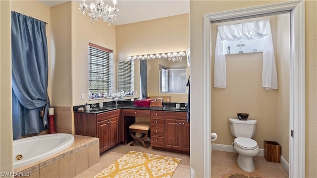 bathroom with tile patterned floors, vanity, toilet, and an inviting chandelier