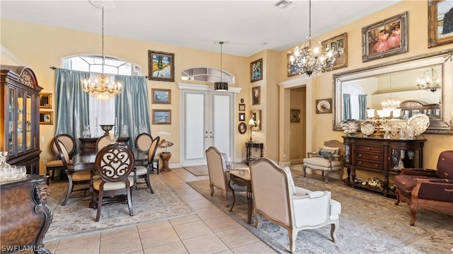 tiled dining space with french doors and a chandelier