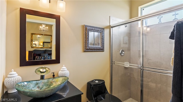 bathroom with vanity and a shower with door