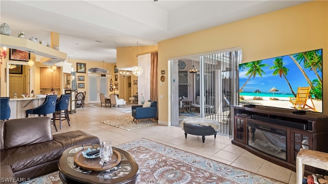 living room with a chandelier and light tile patterned floors