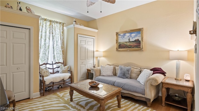 living room with light hardwood / wood-style floors and ceiling fan