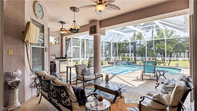 view of patio / terrace with a lanai and a swimming pool with hot tub