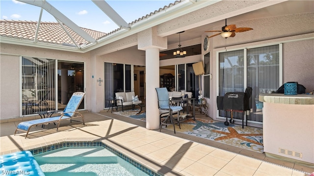 exterior space featuring ceiling fan, a patio, and glass enclosure