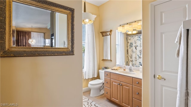 bathroom featuring tile patterned flooring, vanity, toilet, and lofted ceiling