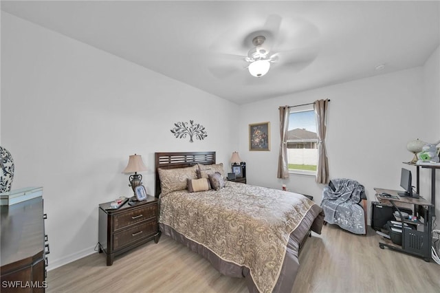 bedroom with ceiling fan and light hardwood / wood-style floors