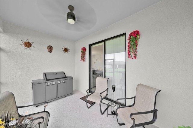 living area with ceiling fan and light colored carpet