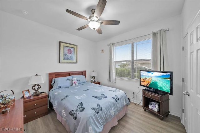 bedroom featuring light wood-type flooring and ceiling fan