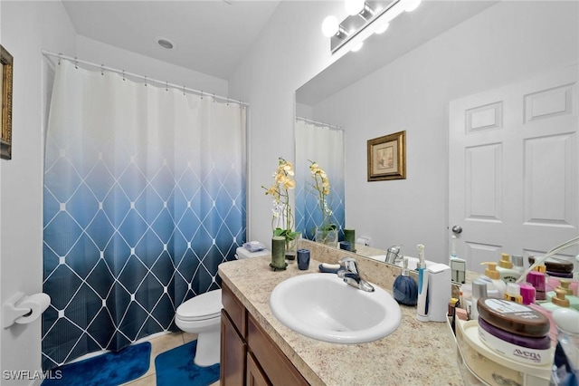 bathroom featuring toilet, vanity, and tile patterned flooring