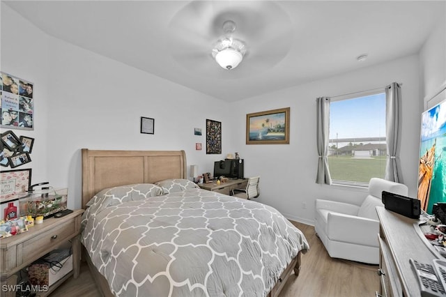 bedroom with ceiling fan and light hardwood / wood-style floors