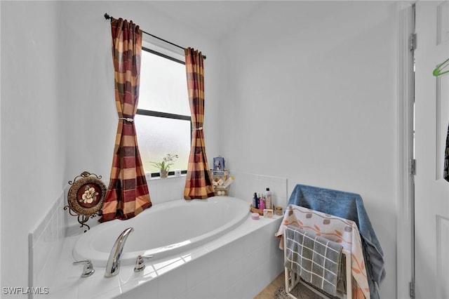 bathroom with tiled bath