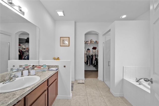 bathroom with tile patterned floors, vanity, and separate shower and tub