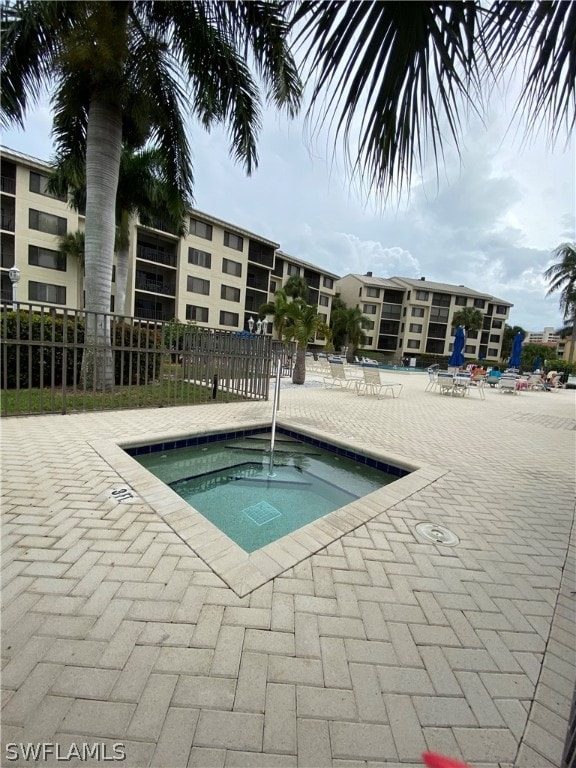 view of swimming pool featuring a patio area and a community hot tub