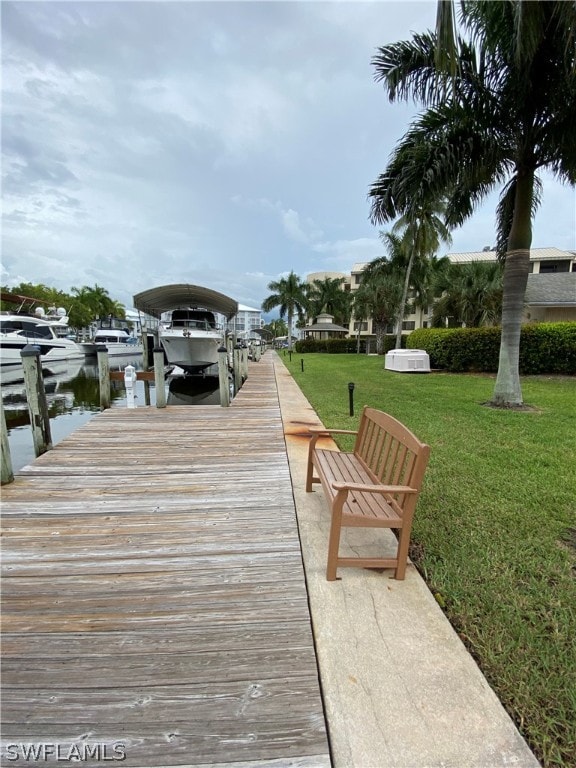 dock area featuring a water view and a yard