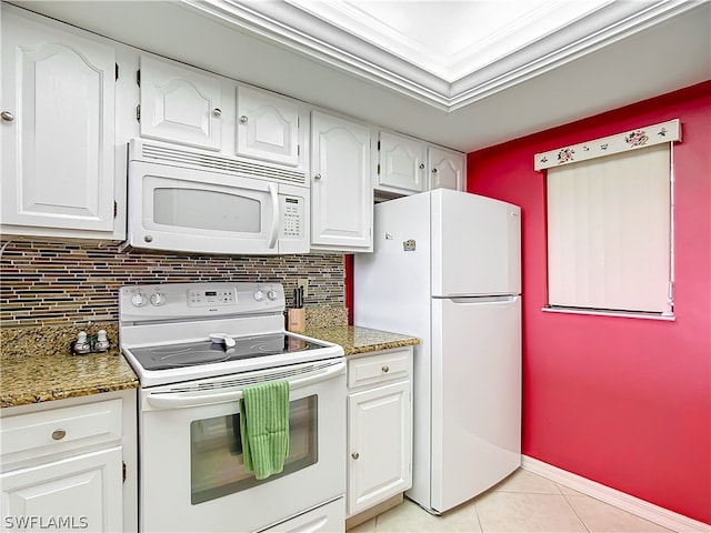 kitchen featuring white cabinets, white appliances, and dark stone counters