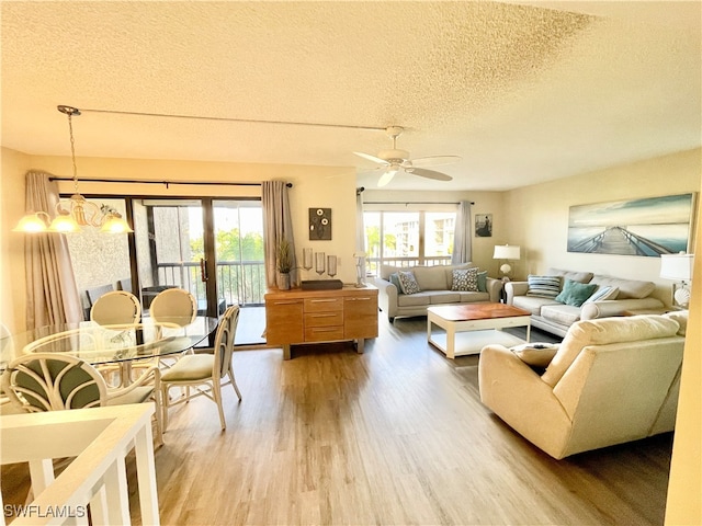 living room with a wealth of natural light, hardwood / wood-style floors, and a textured ceiling