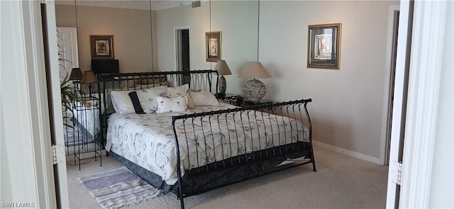 carpeted bedroom featuring baseboards