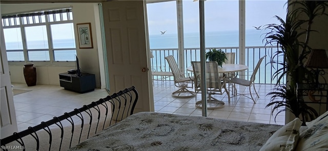 tiled dining room featuring a water view