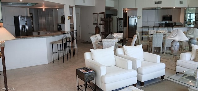 living room with light tile patterned floors and visible vents