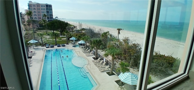 view of swimming pool featuring a beach view and a water view