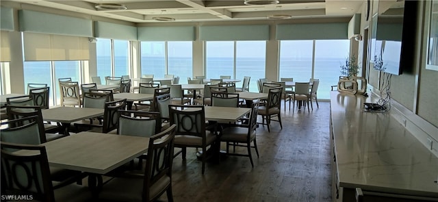 dining space with a water view, dark hardwood / wood-style floors, and coffered ceiling