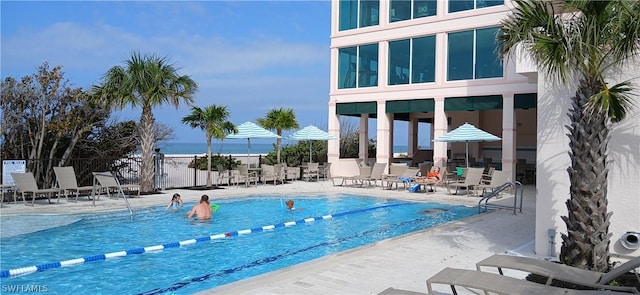 pool with fence and a patio area