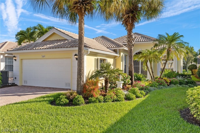 mediterranean / spanish-style house with a front yard and a garage