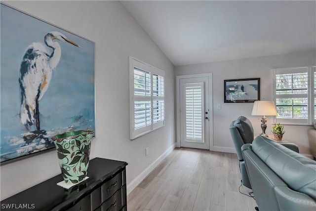 interior space featuring lofted ceiling and light hardwood / wood-style floors